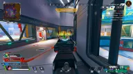 Green chams ESP glowing on an enemy behind cover inside a futuristic tunnel complex — Hydra FULL Apex Legends cheat