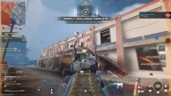 Enemy highlighted by green skeleton ESP over iron sights near a factory stairway — Frost BO6, BO7 & Warzone cheat