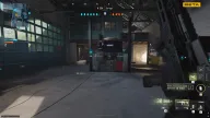 Four enemies revealed through cover by ESP boxes with names and distances in a garage cheat for Frost Modern Warfare 4