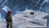 Loot ESP labels an assault rifle and rifle ammo with distances on a clifftop platform — Hydra Rust cheat
