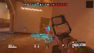 Enemies glowing in pink chams ESP with distance tags seen through walls beside a holographic sight — Frost Pro Rainbow Six Siege cheat